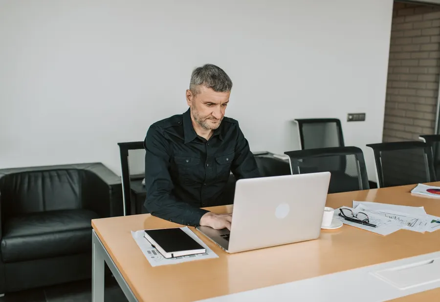 Adult working with a computer in an everyday setting